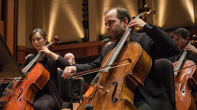 Close-up mage of cello orchestra players
